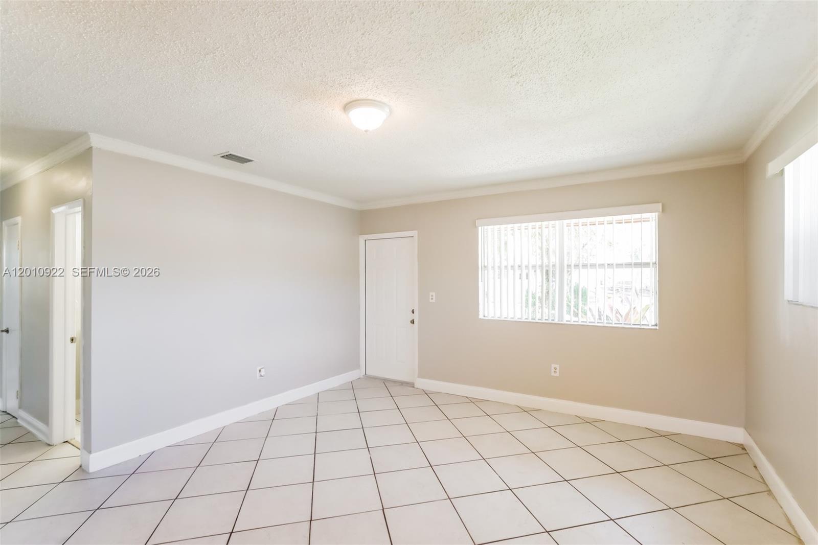 11460 Southwest 199th Street Miami, FL 33157 - Photo 3 of 18 a view of an empty room and window