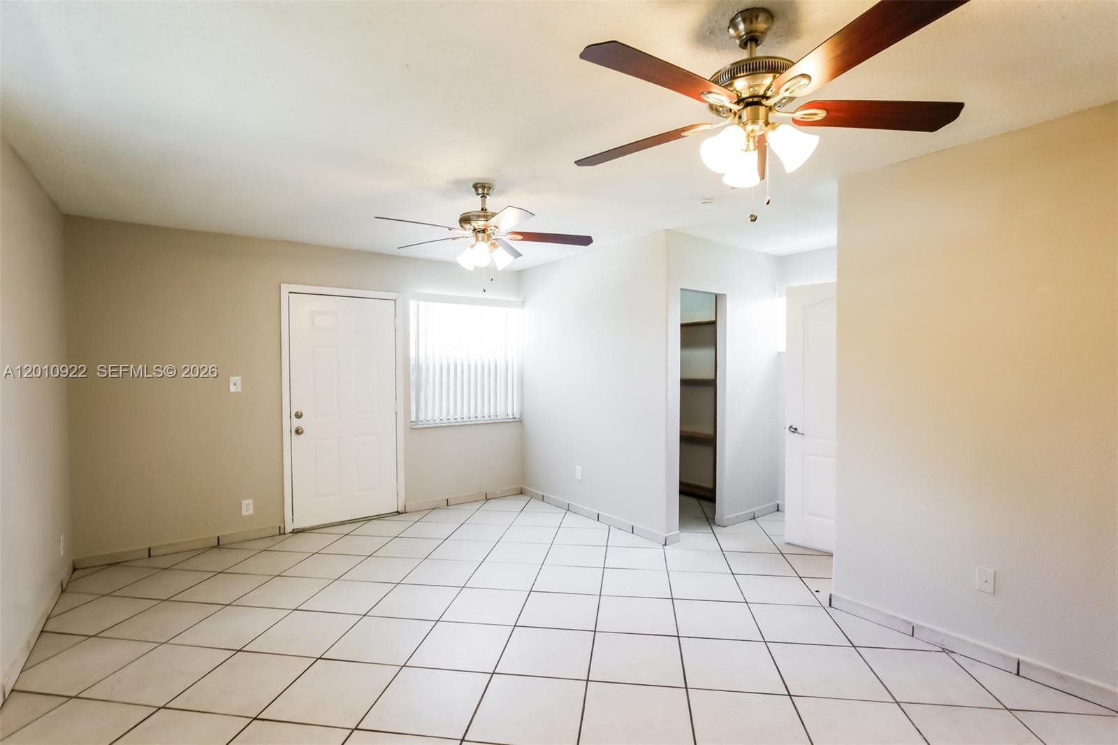 11460 Southwest 199th Street Miami, FL 33157 - Photo 9 of 18 wooden floor in an empty room and a chandelier fan