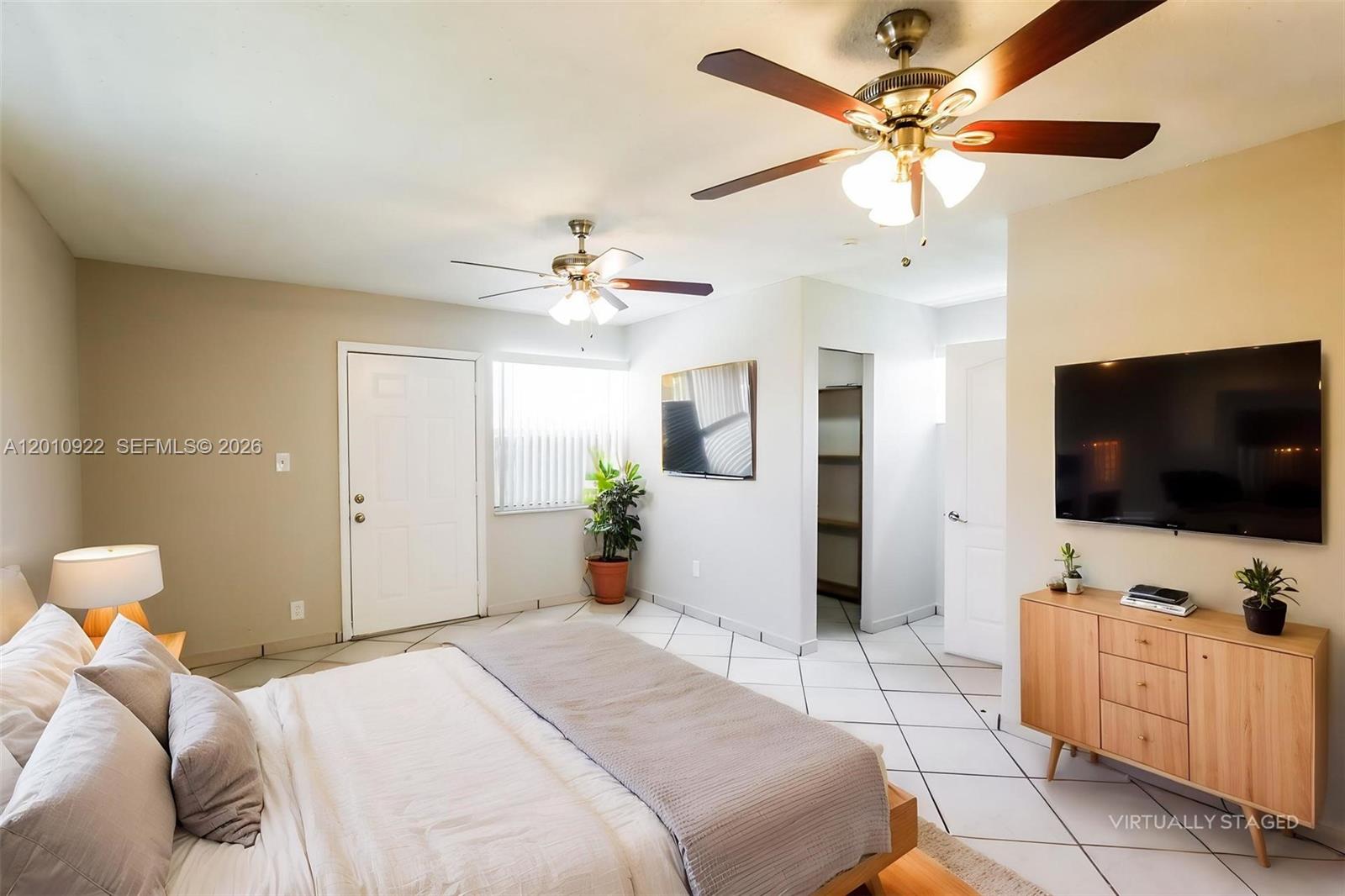 11460 Southwest 199th Street Miami, FL 33157 - Photo 10 of 18 a bedroom with a bed and a flat screen tv