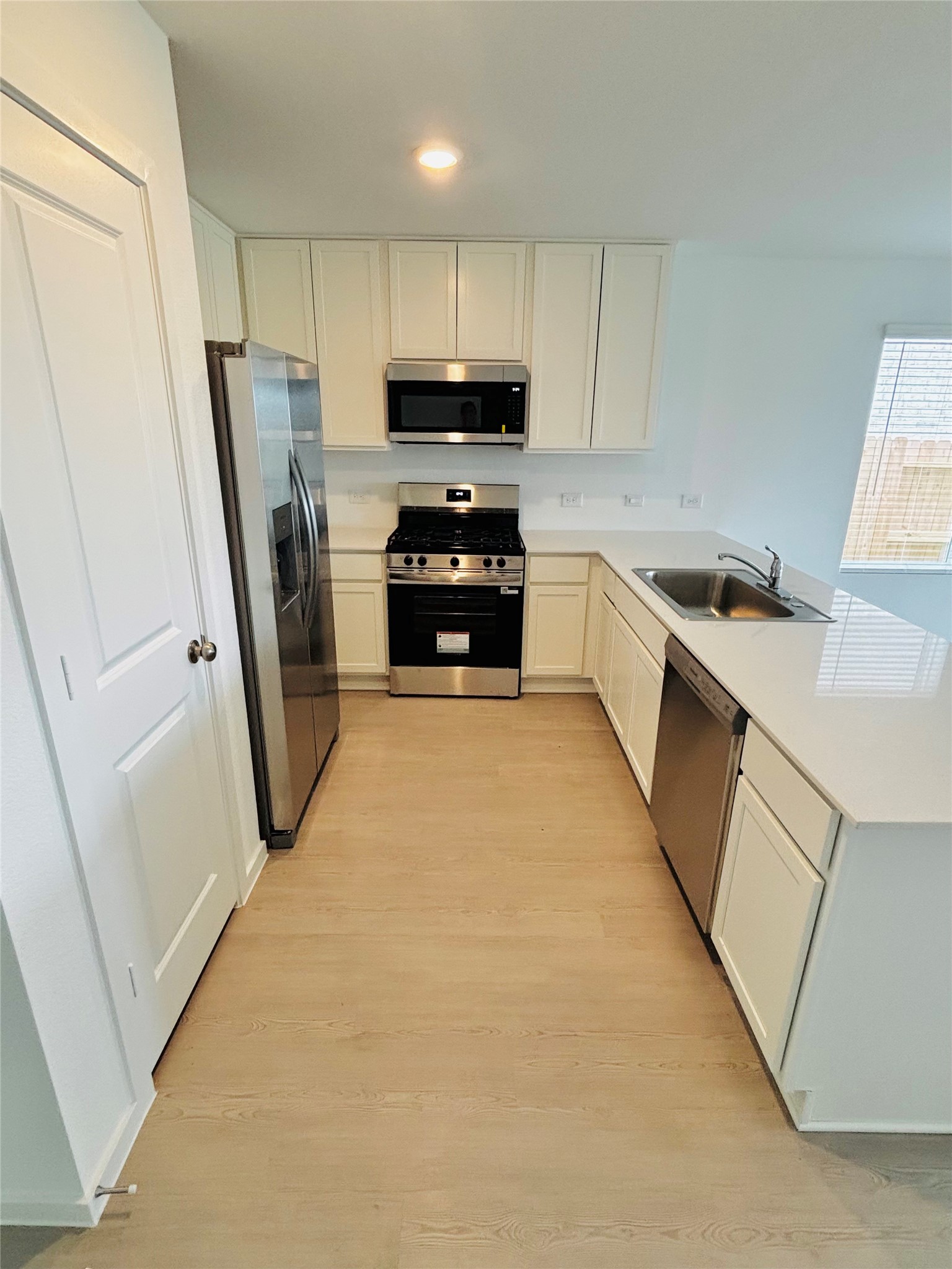2126 Mosaic Vly Court Angleton, TX 77515 - Photo 8 of 40 a kitchen with granite countertop a refrigerator a sink a stove a washer dryer and cabinets