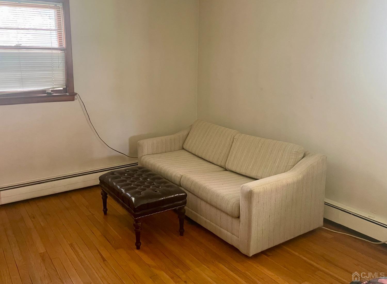 336 Dutch Neck Road East Windsor, NJ 08520 - Photo 9 of 16 a living room with a couch and a window