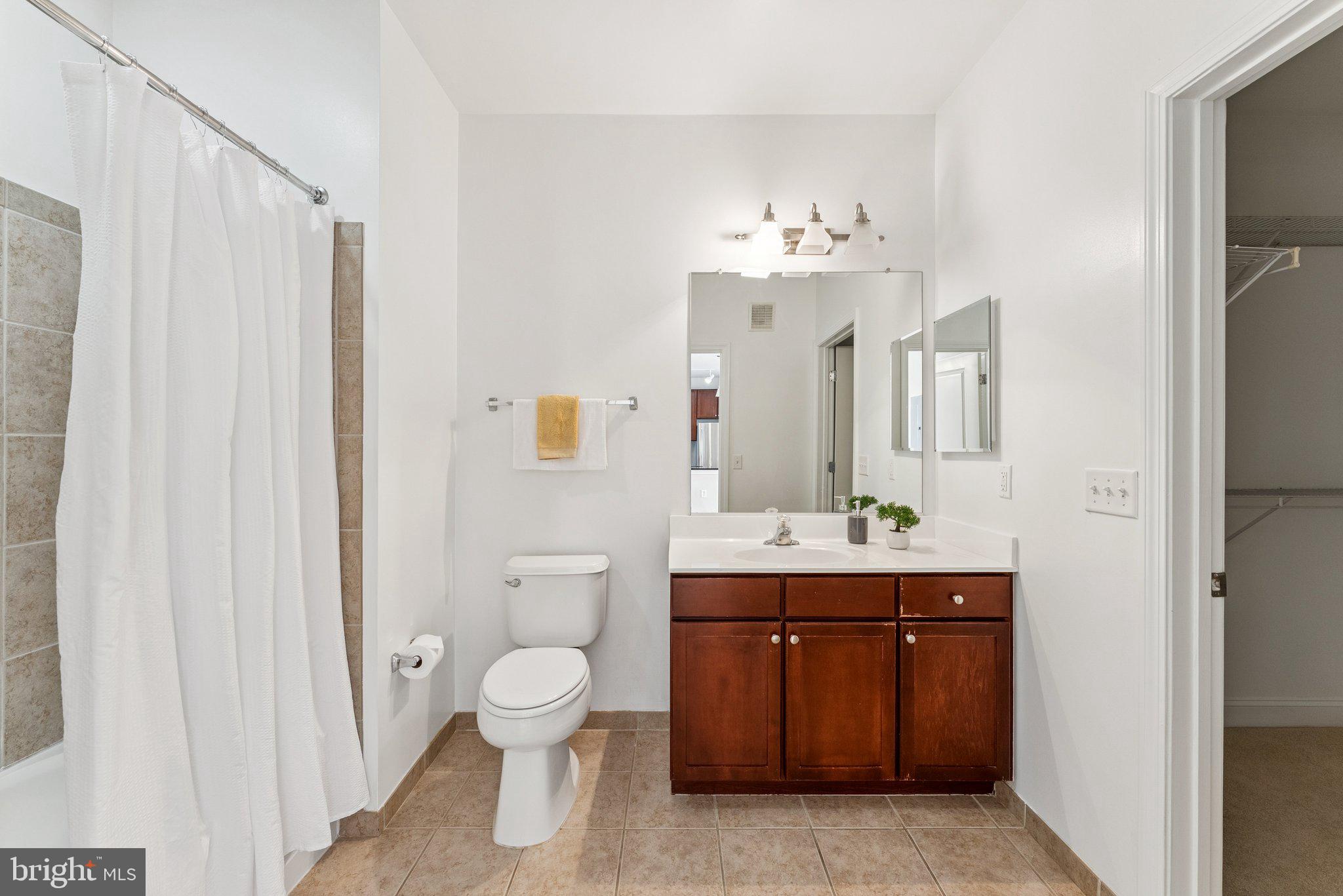 1391 Pennsylvania Ave. Southeast, Unit 403 Washington, DC 20003 - Photo 13 of 34 a spacious bathroom with a toilet sink and mirror