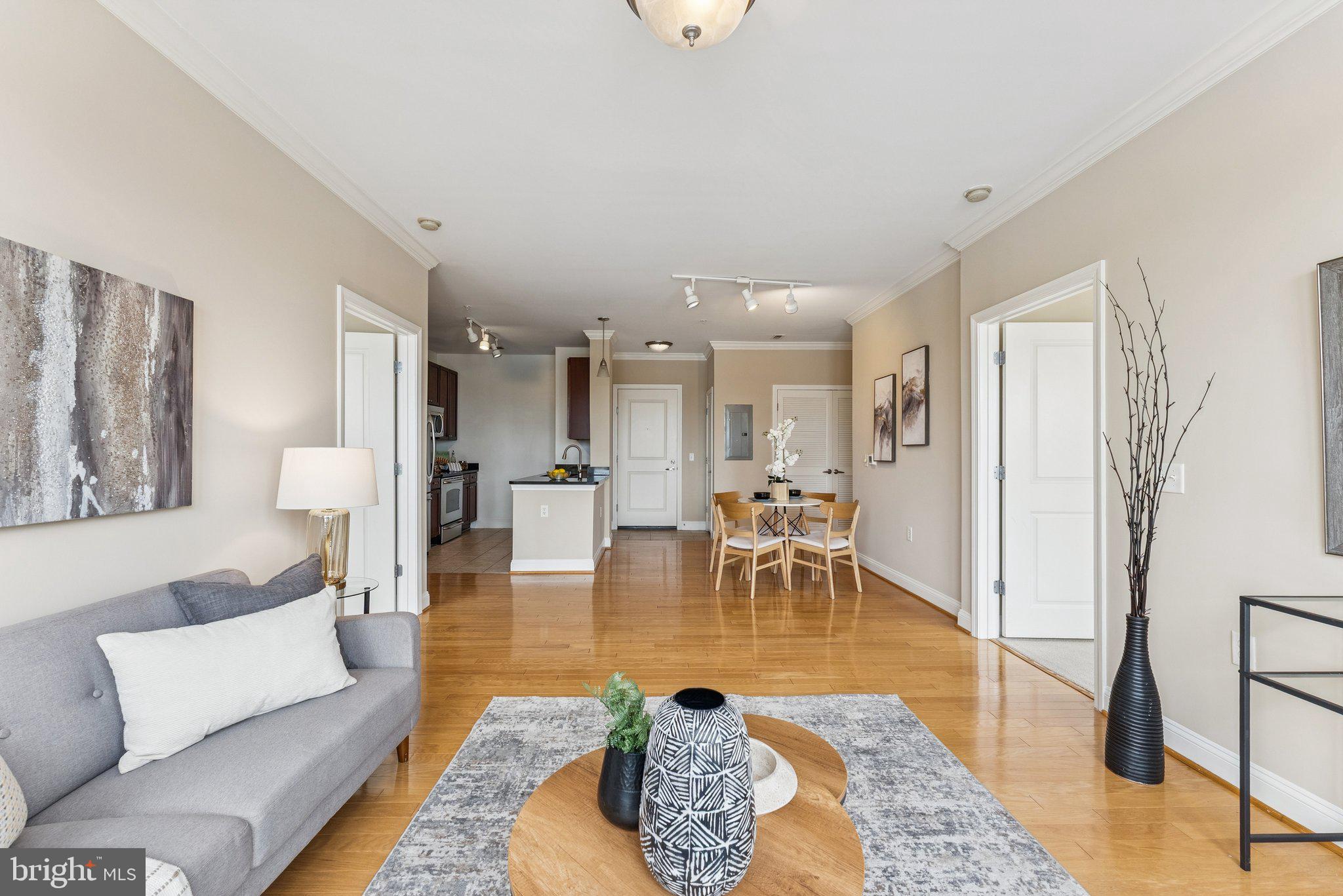 1391 Pennsylvania Ave. Southeast, Unit 403 Washington, DC 20003 - Photo 2 of 34 a living room with furniture wooden floor and a table