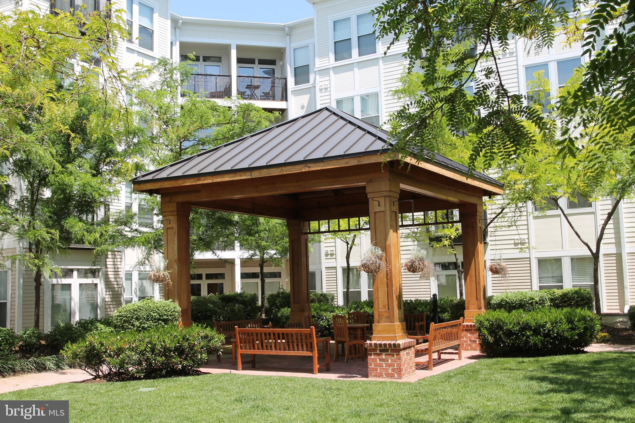 1391 Pennsylvania Ave. Southeast, Unit 403 Washington, DC 20003 - Photo 25 of 34 a view of house with backyard outdoor seating and plants