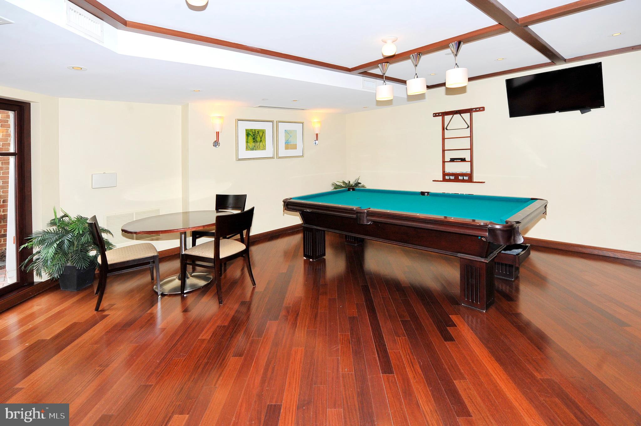 1391 Pennsylvania Ave. Southeast, Unit 403 Washington, DC 20003 - Photo 28 of 34 a room with wooden floor pool table and windows
