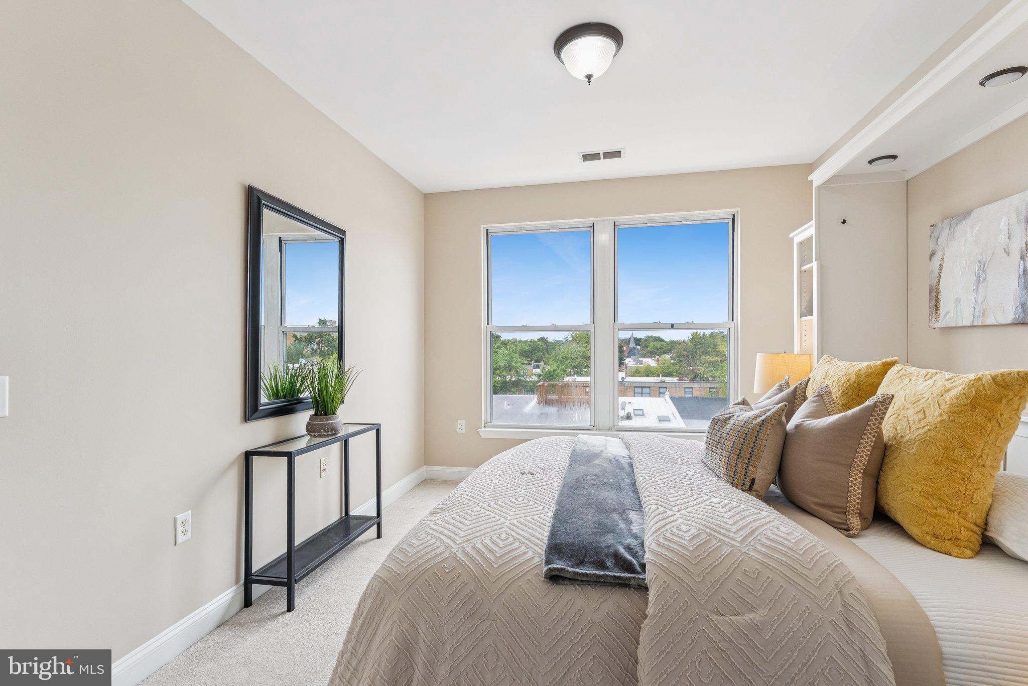 1391 Pennsylvania Ave. Southeast, Unit 403 Washington, DC 20003 - Photo 6 of 34 a living room with a bed furniture and a large window
