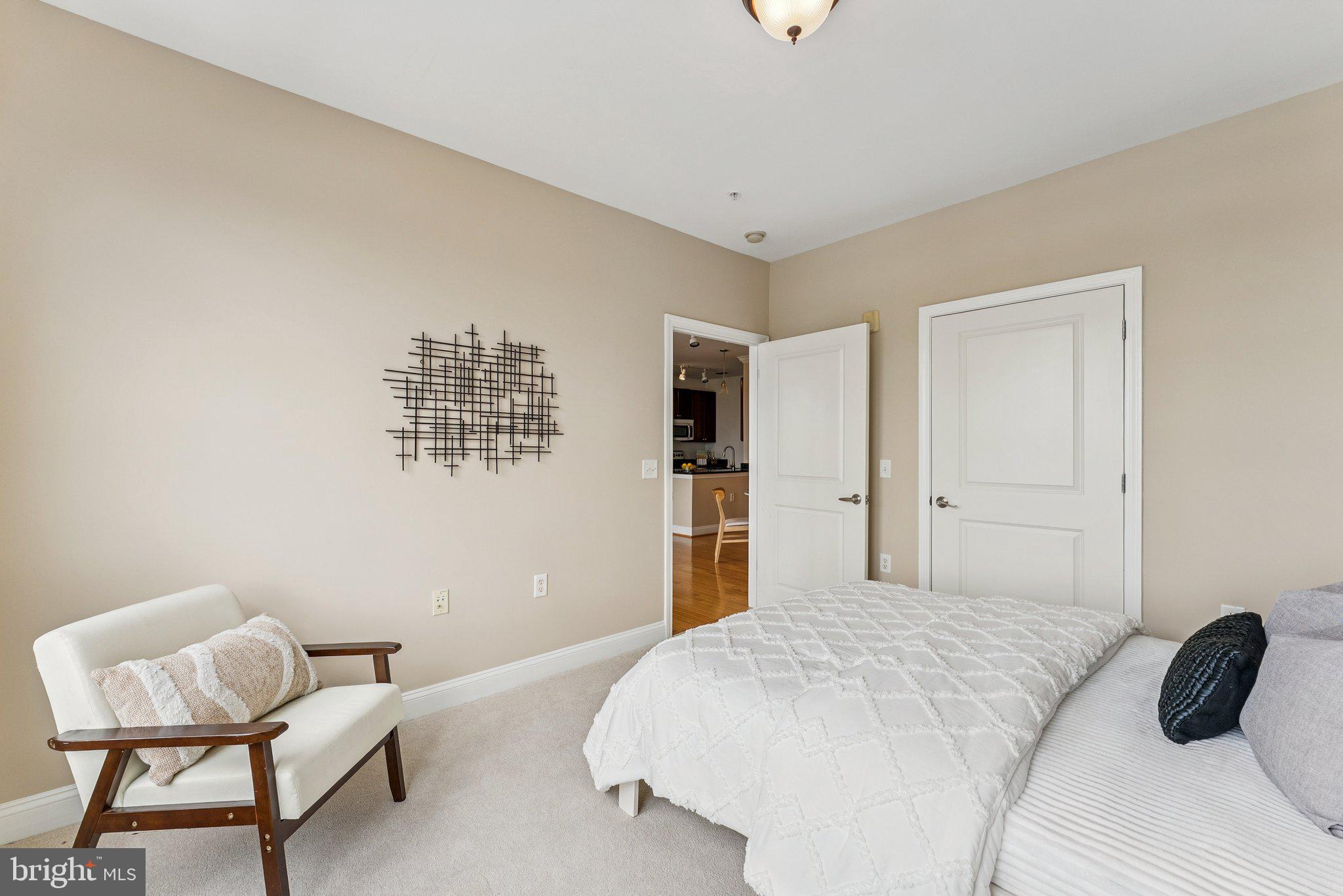 1391 Pennsylvania Ave. Southeast, Unit 403 Washington, DC 20003 - Photo 10 of 34 a bedroom with a bed and a chair