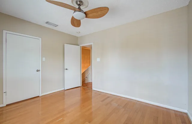 a view of walk in closet with empty racks