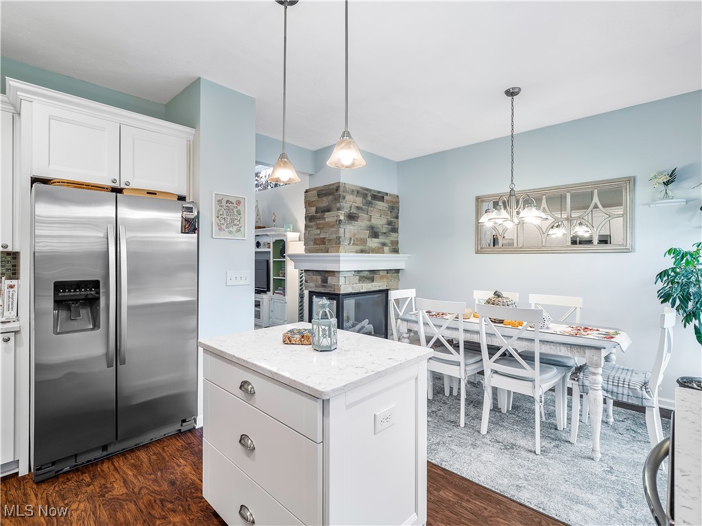 175 Vineyard Road Avon Lake, OH 44012 - Photo 10 of 42 Kitchen with a center island, dark wood-type flooring, stainless steel fridge with ice dispenser, a fireplace, and white cabinets