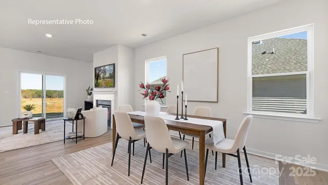 a dining room with furniture and wooden floor