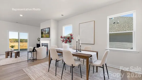 a dining room with furniture and wooden floor