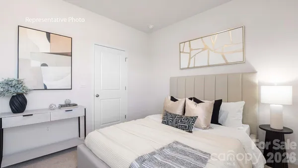 a bedroom with a bed and a mirror