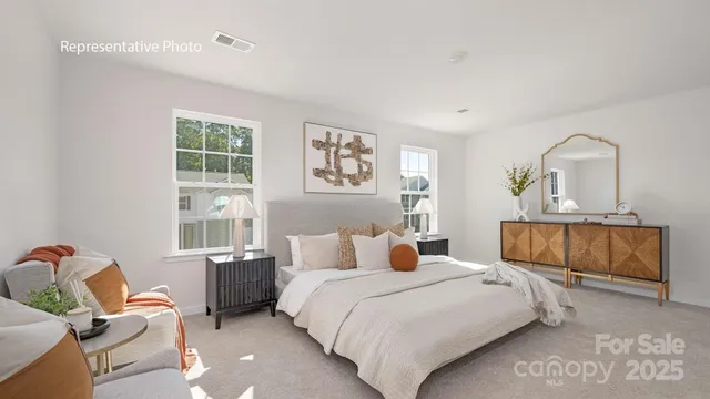 a bedroom with a bed a couch and dresser