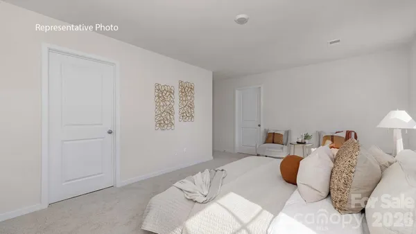 a bedroom with a bed and a lamp
