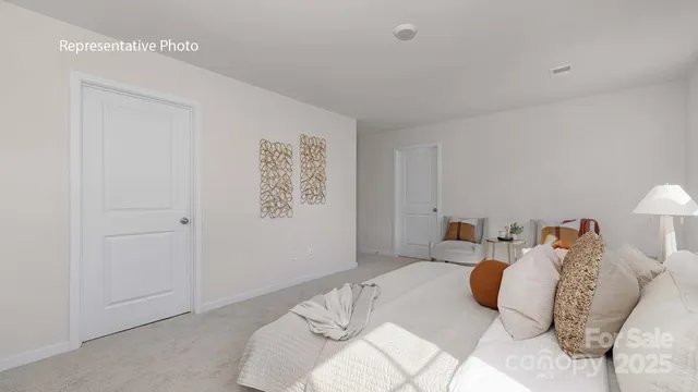 a bedroom with a bed and a lamp