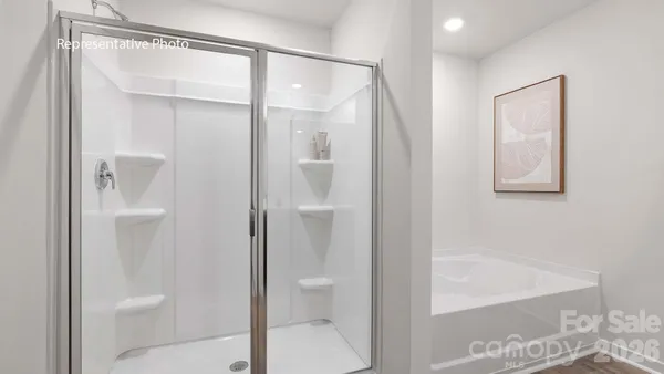 a bathroom with a glass shower door and a toilet