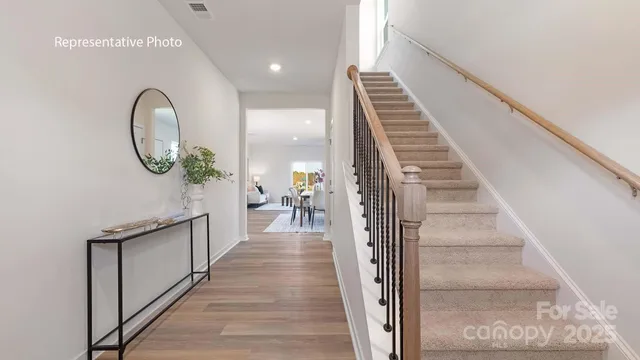 a view of a hallway with wooden floor and entryway