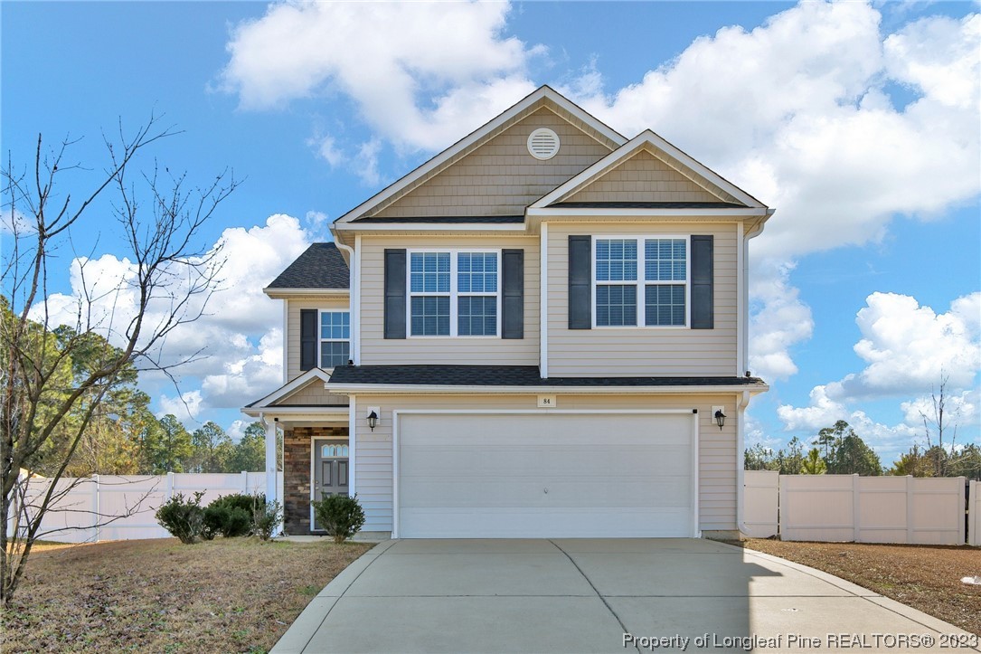 84 Loyalist Road Cameron, NC 28326 - Photo 1 of 40 a front view of a house with a yard and garage