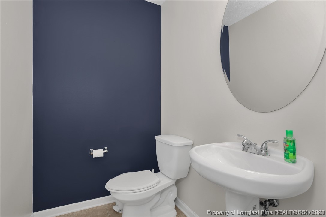 84 Loyalist Road Cameron, NC 28326 - Photo 11 of 40 a white toilet sitting next to a bathroom sink