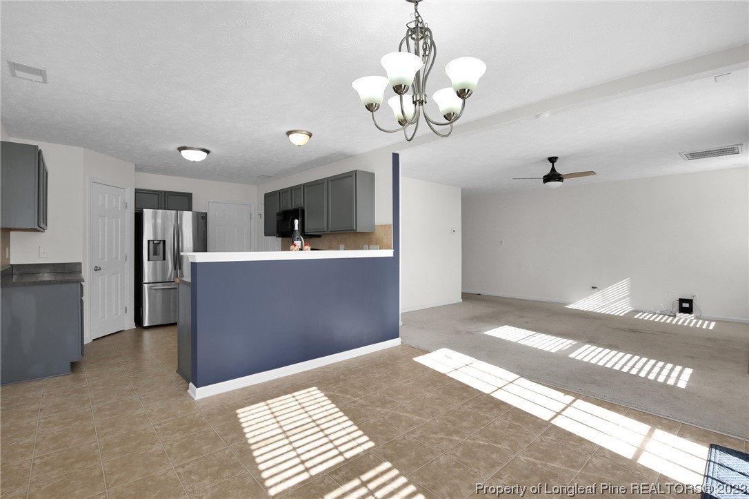 84 Loyalist Road Cameron, NC 28326 - Photo 13 of 40 a view of a room with a chandelier and wooden floor