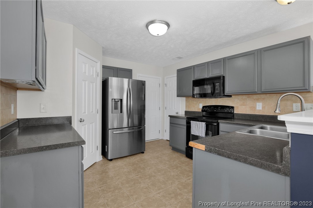 84 Loyalist Road Cameron, NC 28326 - Photo 14 of 40 a kitchen with a refrigerator sink and microwave