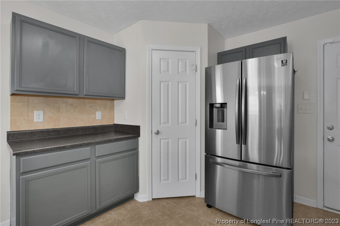 84 Loyalist Road Cameron, NC 28326 - Photo 16 of 40 a kitchen with cabinets and stainless steel appliances