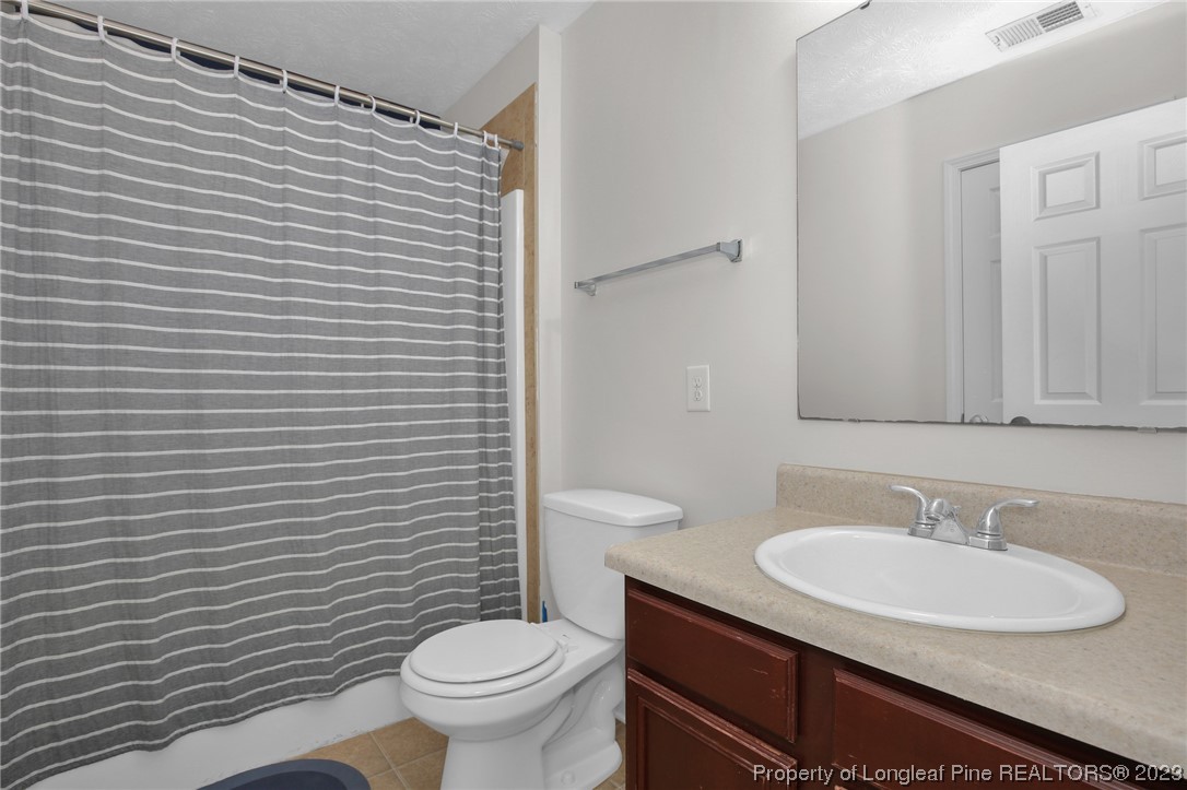 84 Loyalist Road Cameron, NC 28326 - Photo 21 of 40 a bathroom with a sink a toilet and mirror
