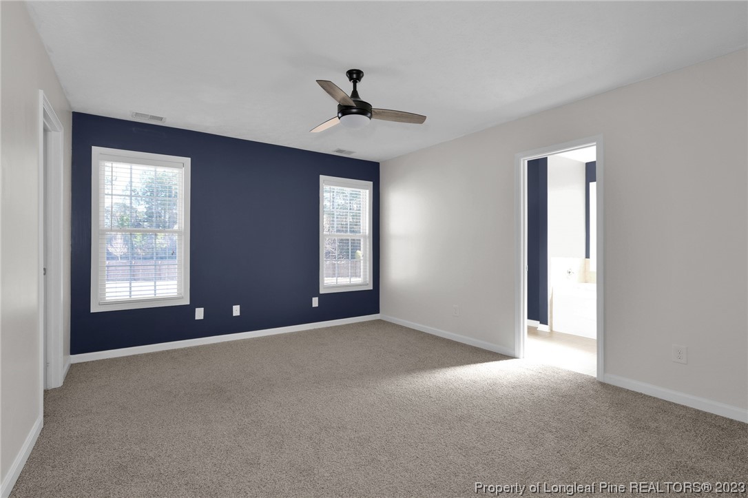 84 Loyalist Road Cameron, NC 28326 - Photo 25 of 40 an empty room with windows and ceiling fan