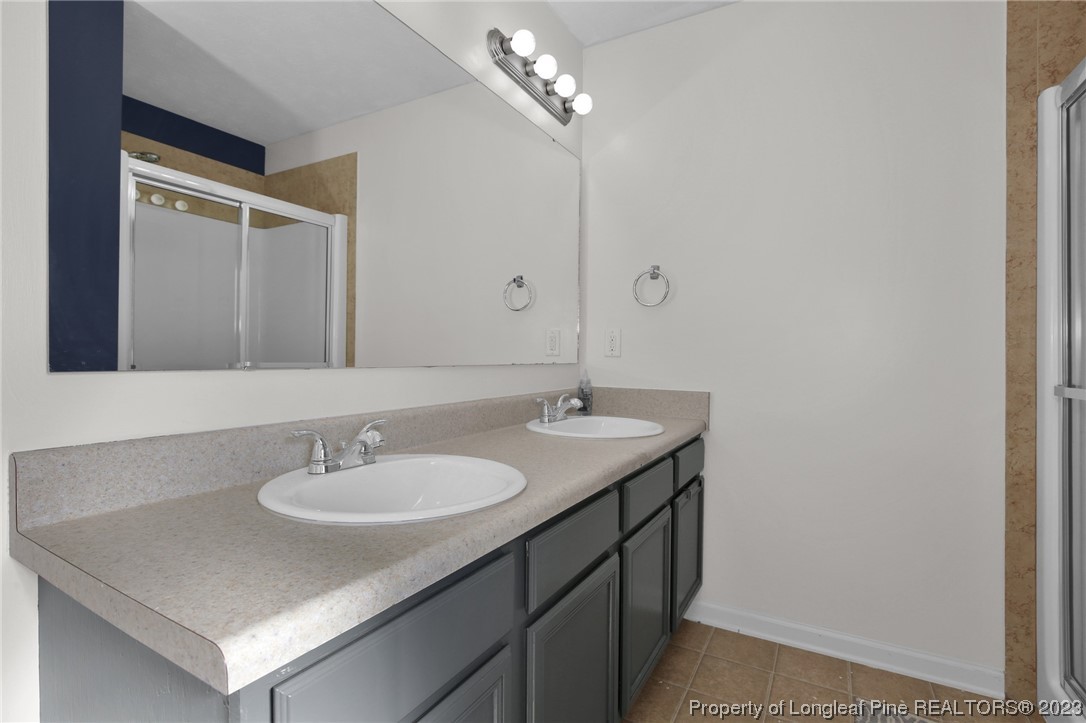 84 Loyalist Road Cameron, NC 28326 - Photo 29 of 40 a bathroom with a sink vanity and a mirror