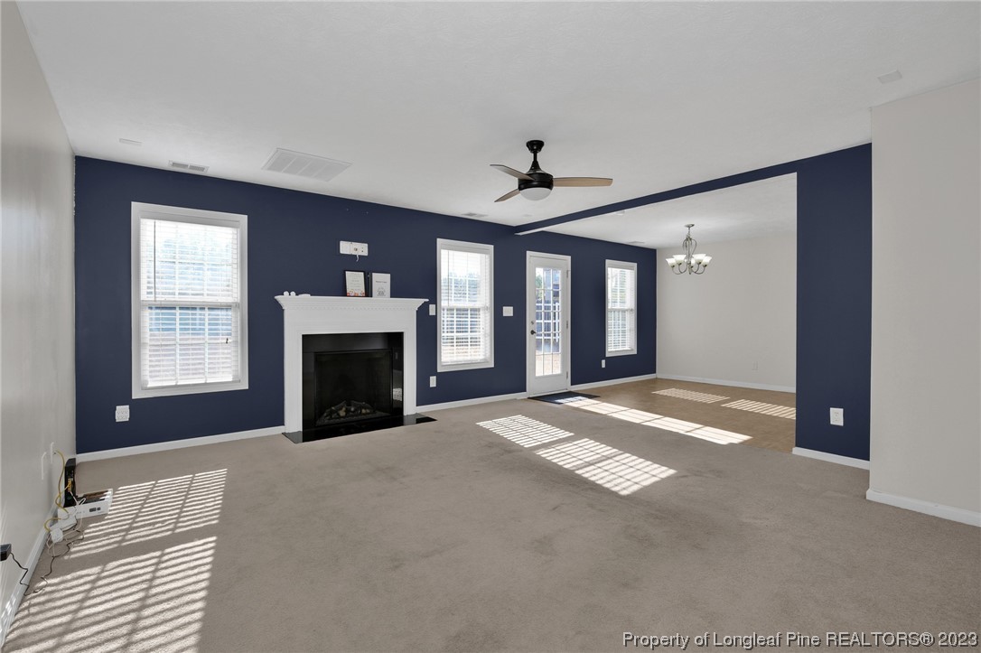84 Loyalist Road Cameron, NC 28326 - Photo 3 of 40 a view of an empty room with a fireplace and a window