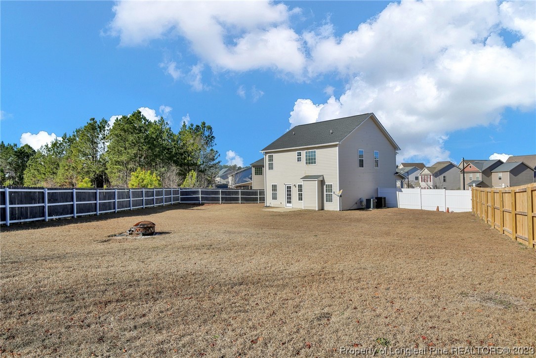 84 Loyalist Road Cameron, NC 28326 - Photo 32 of 40 a view of a house with backyard and a tree