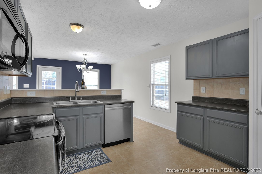 84 Loyalist Road Cameron, NC 28326 - Photo 4 of 40 a kitchen with stainless steel appliances granite countertop a sink stove and cabinets
