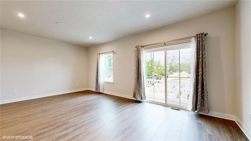 4908 Spruce Road Gibsonia, PA 15044 - Photo 12 of 39 a view of an empty room with wooden floor and a window