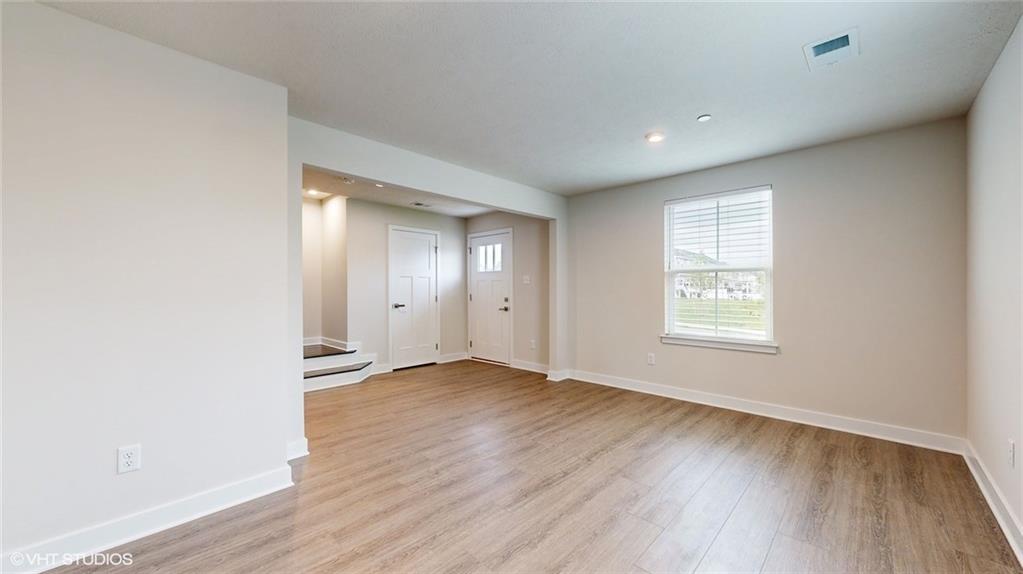 4908 Spruce Road Gibsonia, PA 15044 - Photo 4 of 39 an empty room with wooden floor and windows