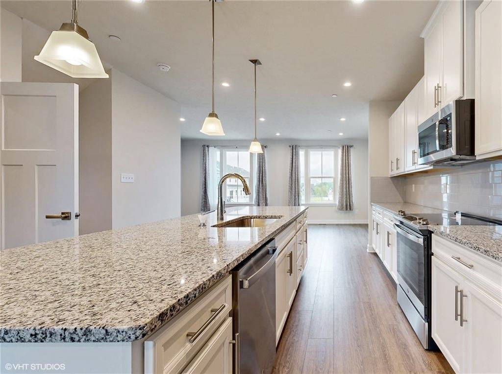 4908 Spruce Road Gibsonia, PA 15044 - Photo 8 of 39 a large kitchen with granite countertop a large island in the center