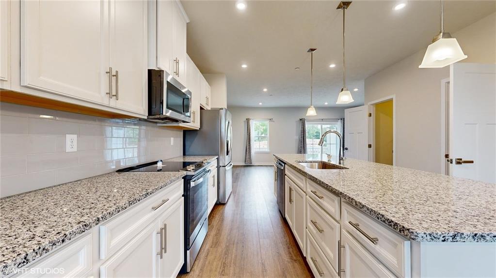 4908 Spruce Road Gibsonia, PA 15044 - Photo 9 of 39 a large kitchen with stainless steel appliances granite countertop plenty wooden cabinets counter space a sink and a wooden floor