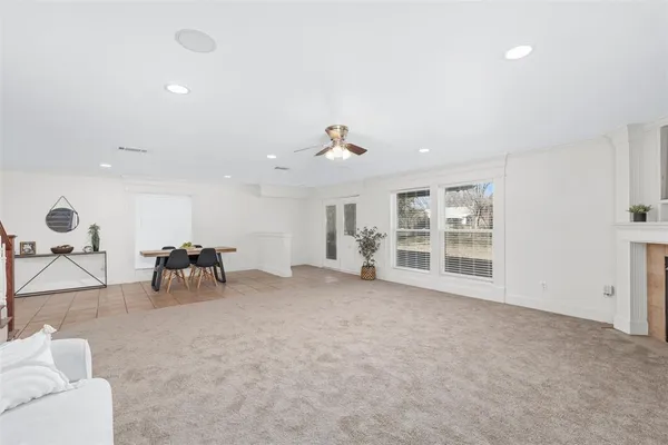 a view of a livingroom with furniture and a ceiling fan