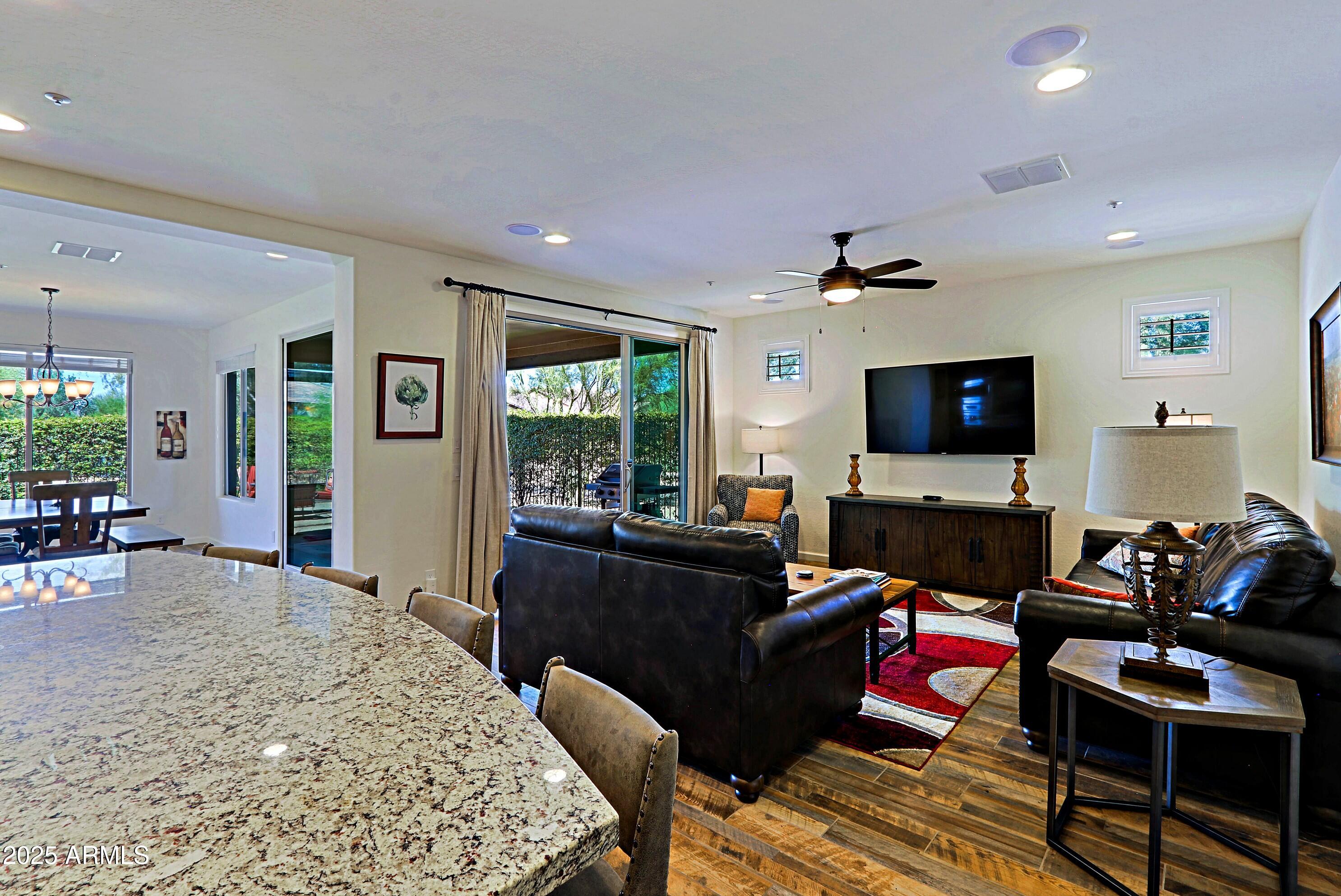 18004 East Silver Sage Lane Rio Verde, AZ 85263 - Photo 19 of 92 a living room with furniture and a flat screen tv