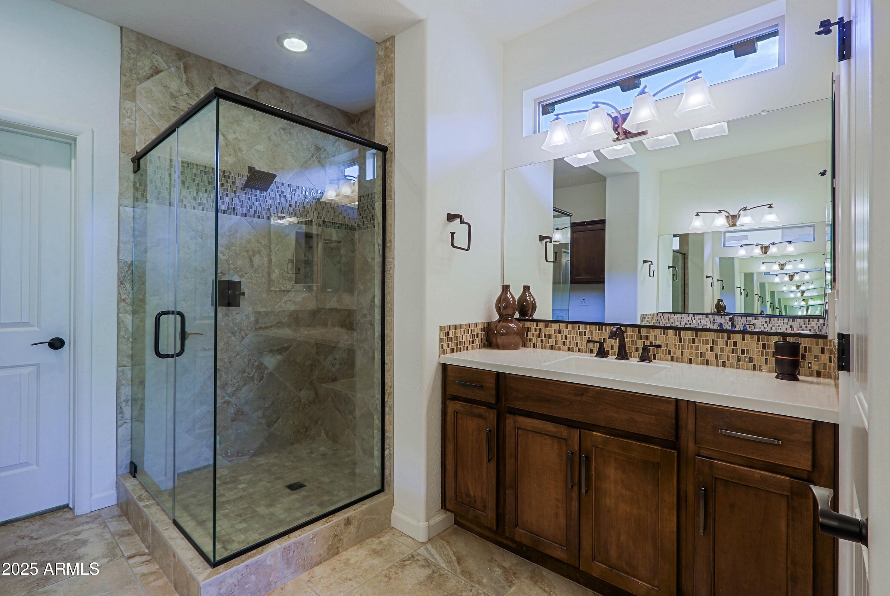 18004 East Silver Sage Lane Rio Verde, AZ 85263 - Photo 31 of 92 a bathroom with a shower sink and mirror