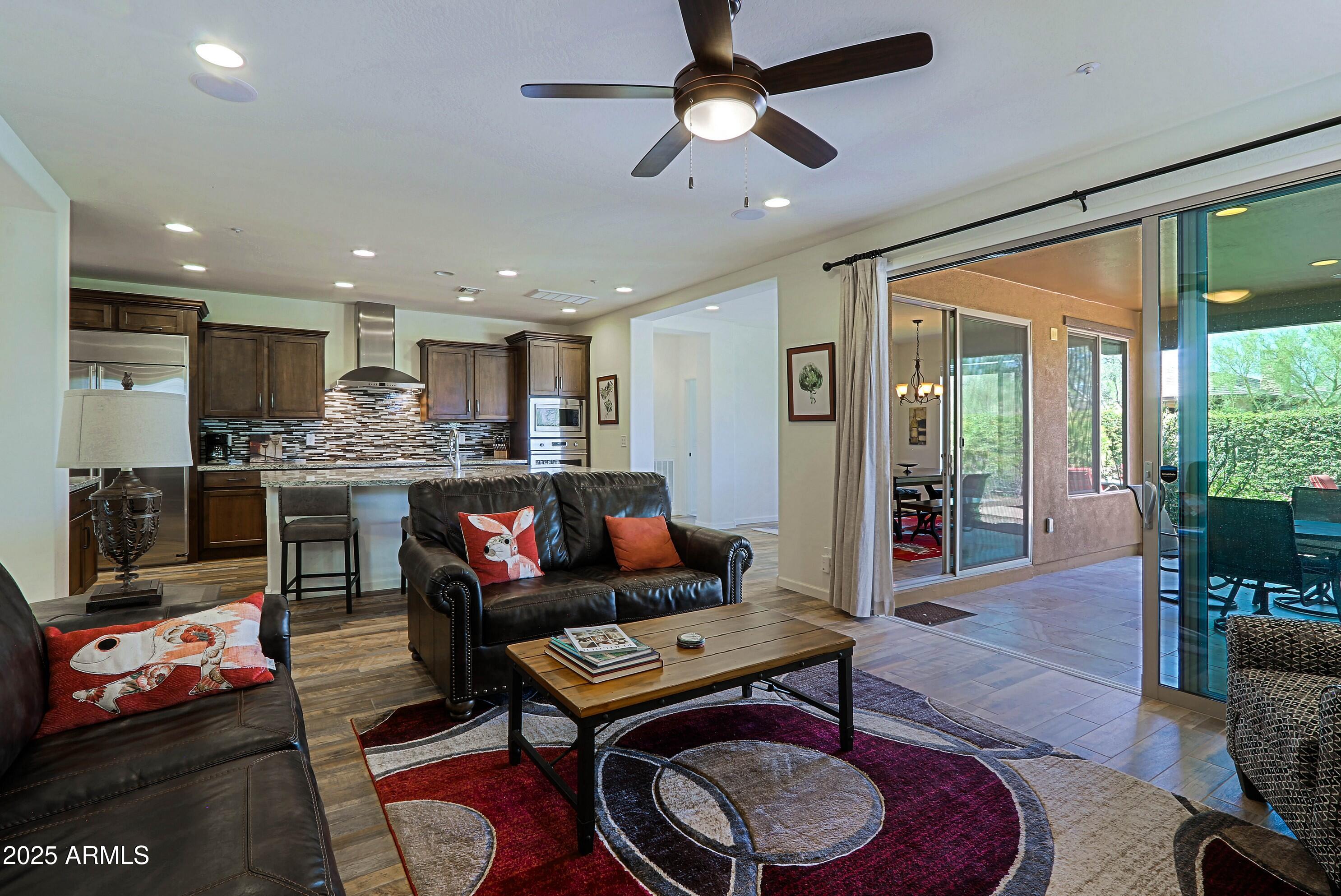 18004 East Silver Sage Lane Rio Verde, AZ 85263 - Photo 3 of 92 a living room with stainless steel appliances kitchen island granite countertop furniture and a rug