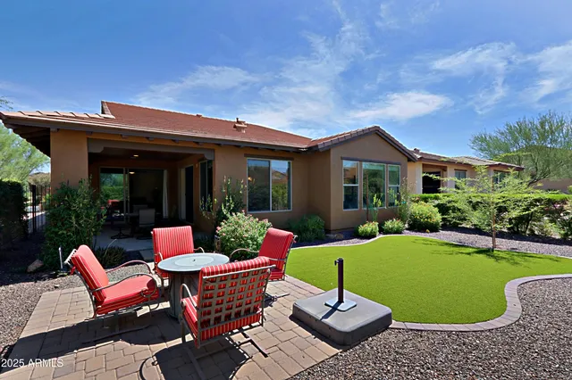 a living room with furniture and a painting