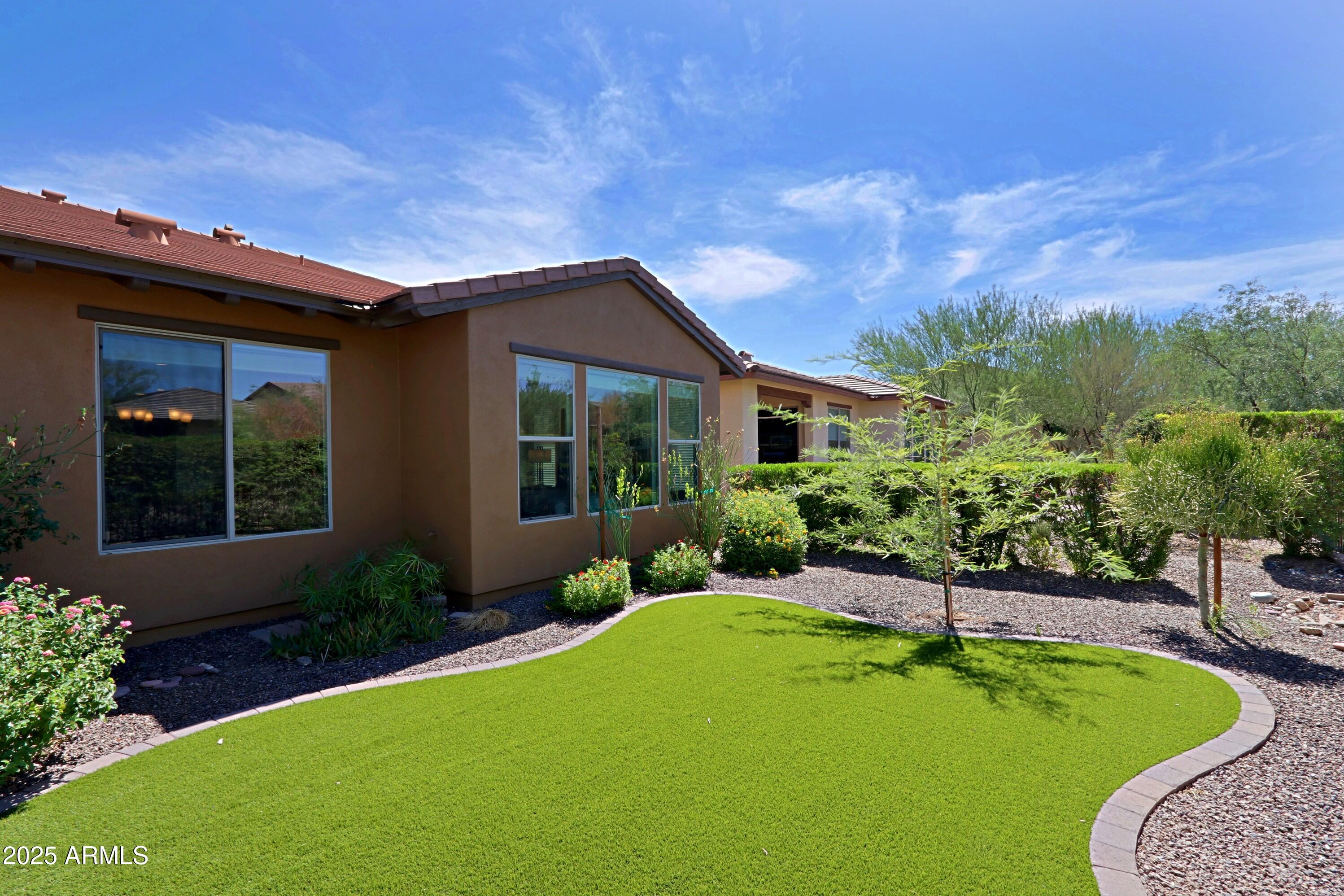 18004 East Silver Sage Lane Rio Verde, AZ 85263 - Photo 50 of 92 a view of a house with swimming pool and a yard