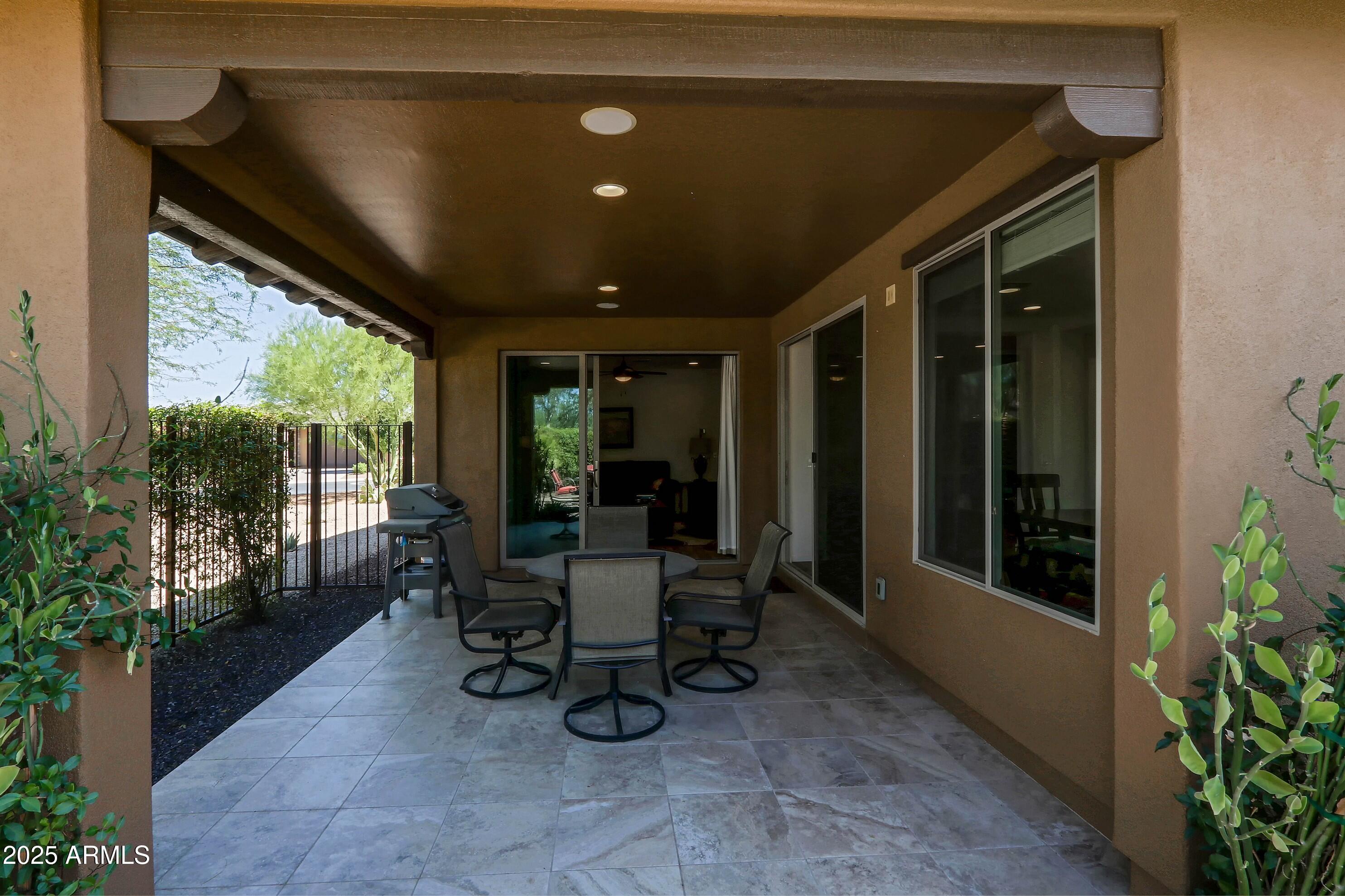 18004 East Silver Sage Lane Rio Verde, AZ 85263 - Photo 54 of 92 a view of a porch with chairs and backyard