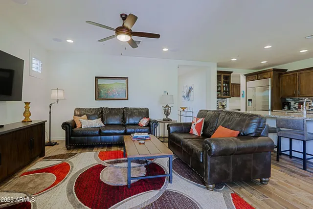 a kitchen with stainless steel appliances granite countertop a kitchen island a table and chairs