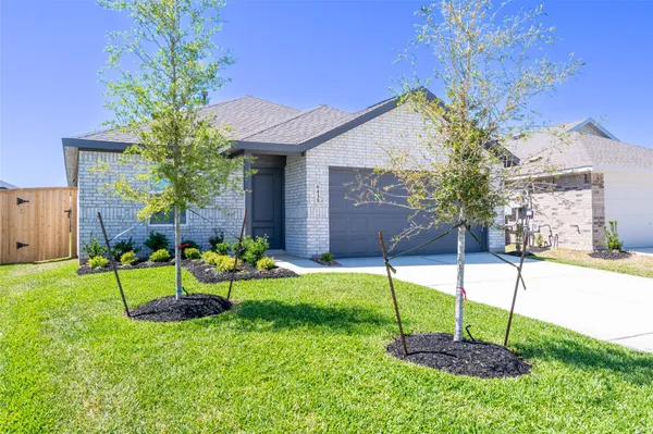 a house view with a sitting space and garden