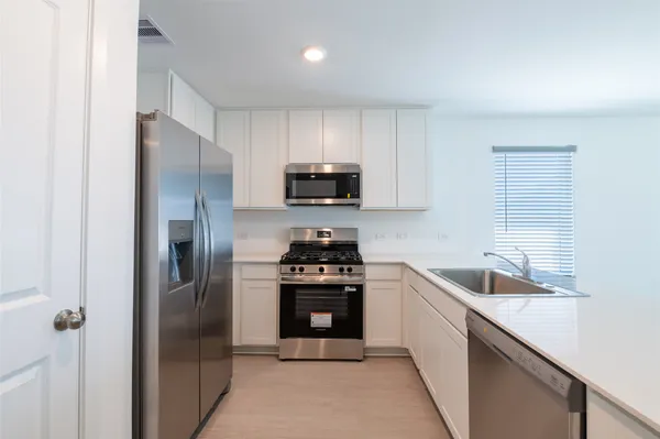 a kitchen with a sink stove and refrigerator