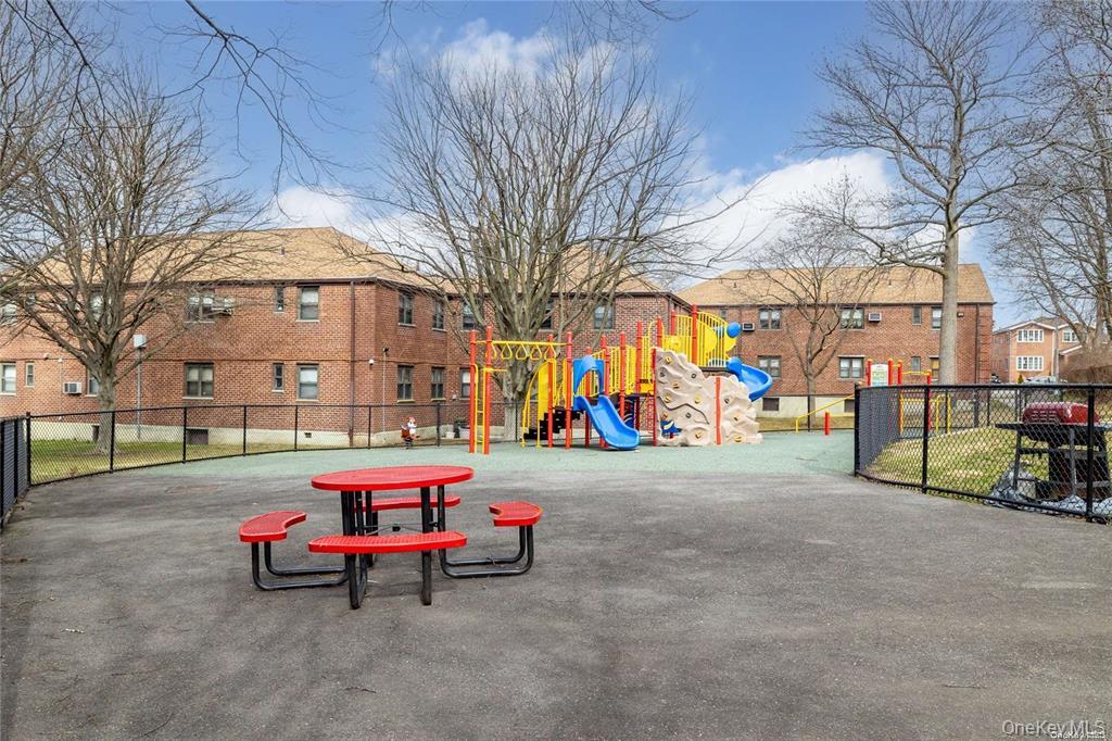 245-48 62nd Avenue, Unit UPPER 2/3BR Queens, NY 11362 - Photo 26 of 29 a backyard of a building with barbeque oven table and chairs