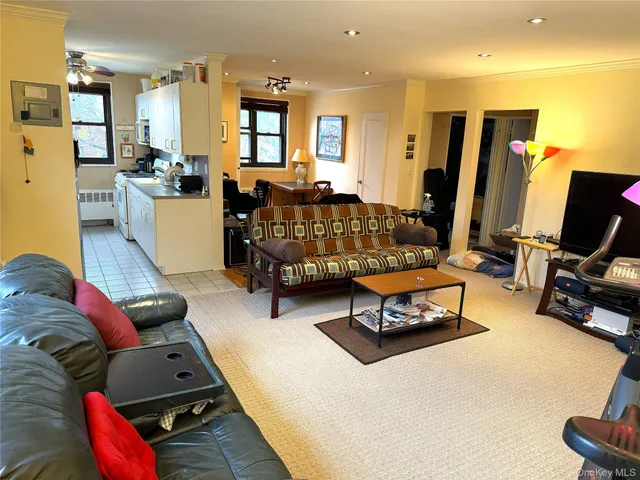 a living room with furniture gym equipment and a large window