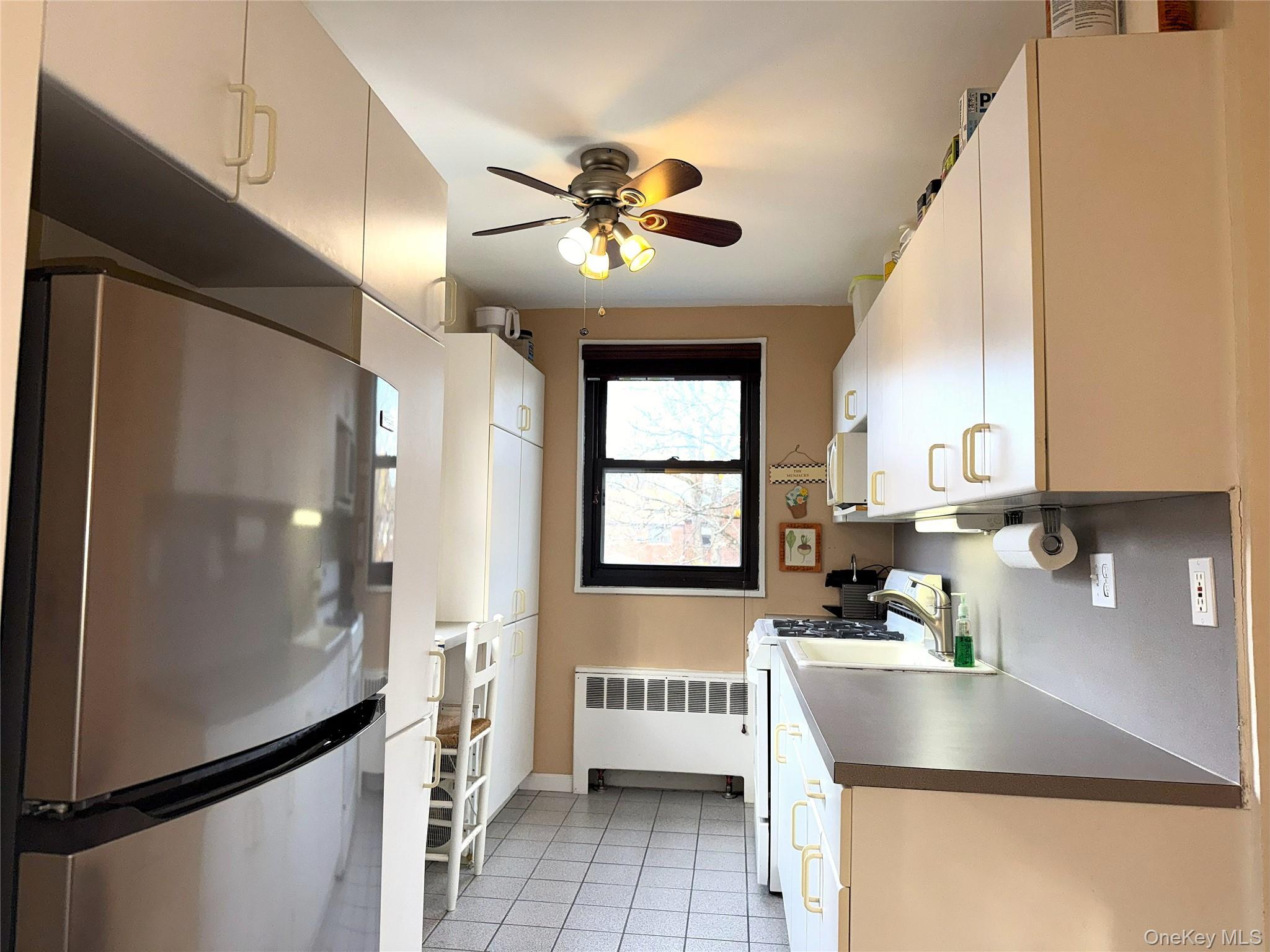245-48 62nd Avenue, Unit UPPER 2/3BR Queens, NY 11362 - Photo 4 of 29 a kitchen with a refrigerator a sink and dishwasher