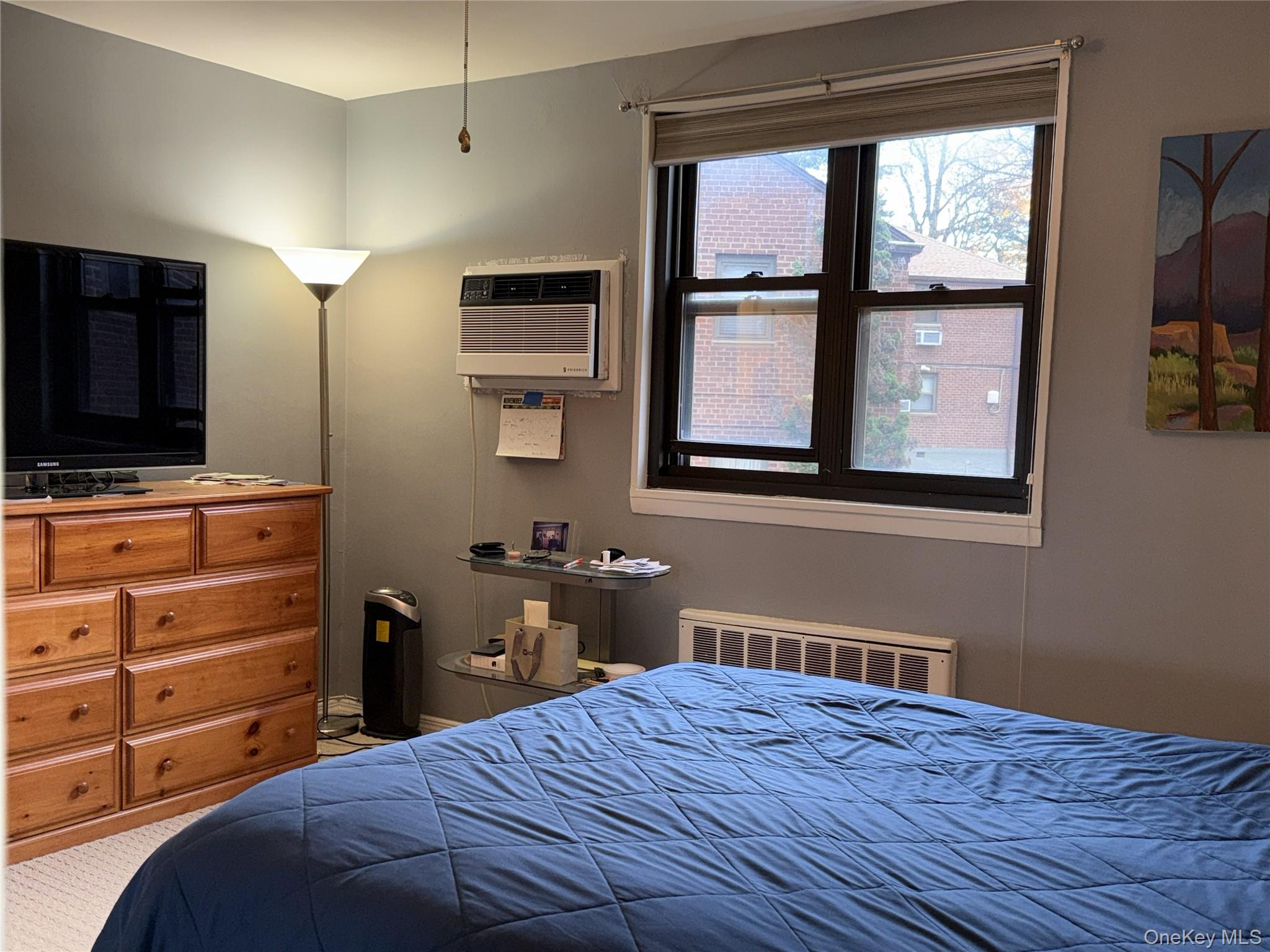 245-48 62nd Avenue, Unit UPPER 2/3BR Queens, NY 11362 - Photo 10 of 29 a bedroom with a bed and a flat tv screen on dresser